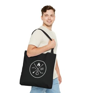 man carrying black makana wild tote bag