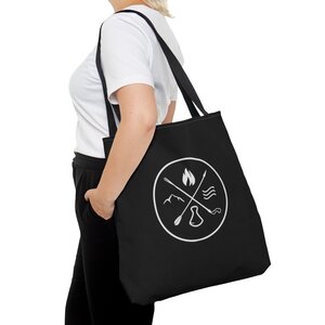 woman carrying black tote bag